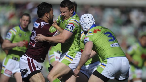 Close call: Raiders halfback Sam Williams makes a tackle against Manly.