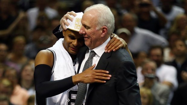 Special moment: Patty Mills celebrates the NBA championship win with Spurs coach Gregg Popovich.