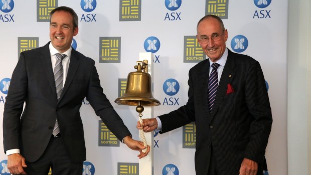 Kerr (left) and South32 chairman David Crawford ring the bell as the miner makes its debut on the ASX.