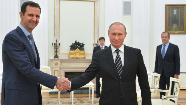 Putin shakes hand with Syrian President Bashar al-Assad in October 2015.
