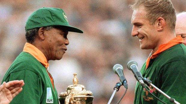 Nelson Mandela presents the William Webb Ellis trophy to South Africa captain Francois Pienaar at the 1995 World Cup.