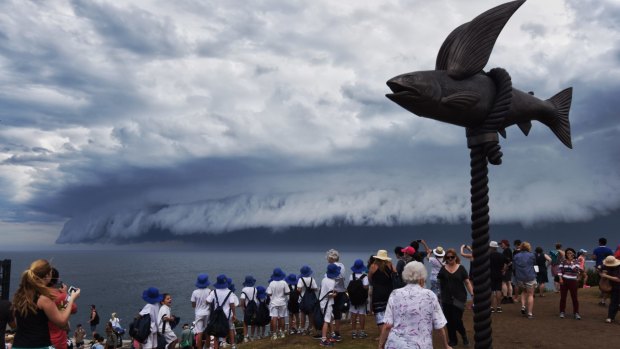 Crowds gather to watch the massive shelf cloud approach the coast near Bondi Beach.