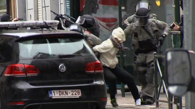 Salah Abdeslam is arrested by police during a raid in Brussels, Belgium.