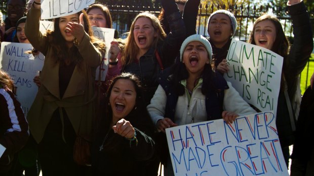 A group of students demonstrate outside of the White House in opposition of President-elect Donald Trump on Saturday.