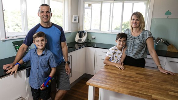 Adam and Michelle Martin in their home with their sons Miller and Isaac.