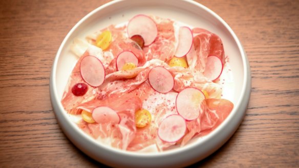Culatello with gapes and radish slices.