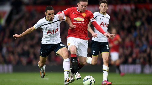 Wayne Rooney of Manchester United shrugs off the challenge from Nabil Bentaleb of Spurs at Old Trafford on Sunday.