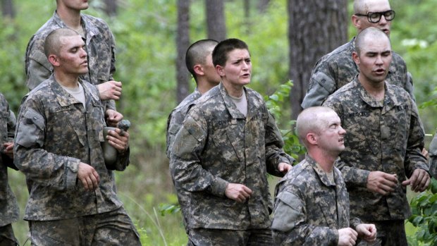 Another of 20 female soldiers, centre, who qualified to start Ranger School, does one of the toughest obstacle courses in US Army training, at Fort Benning, Georgia.