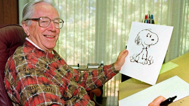 Charles Schulz displays a sketch of his beloved character "Snoopy" in his office in Santa Rosa in 2000.