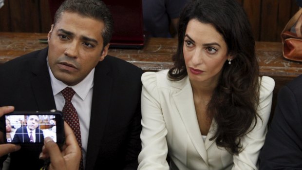 Al Jazeera television journalist Mohamed Fahmy and his lawyer Amal Clooney before hearing the verdict at a court in Cairo.