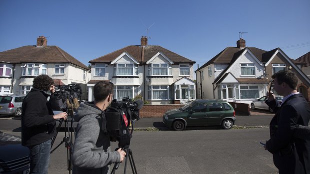 Members of the media stand outside the family home of Navinder Singh Sarao.