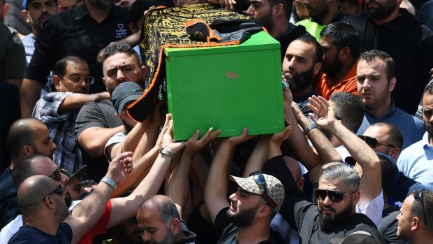 The coffin of schoolboy Jihad Darwiche being carried out of the funeral service at Lakemba Mosque.