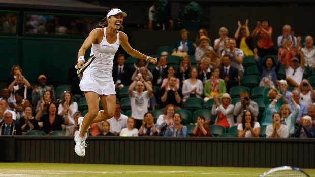 Martina Hingis celebrates after claiming another Wimbledon title.