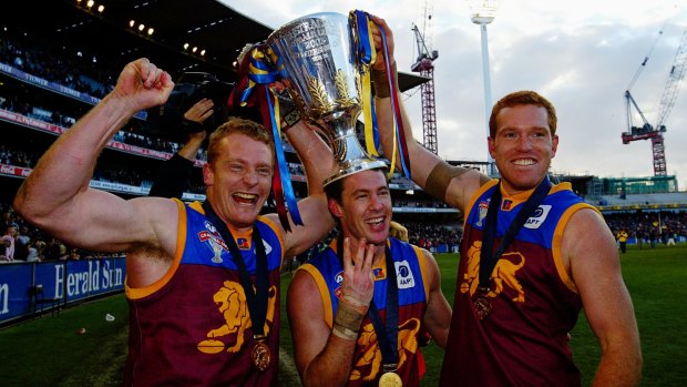 Three of the best: Michael Voss, Craig McCrae and Justin Leppitsch with the AFL premiership cup in 2003.