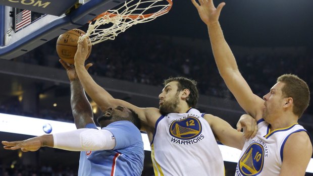 Defensive presence: Los Angeles Clippers forward Glen Davisis contained by Golden State Warriors duo Andrew Bogut and forward David Lee.