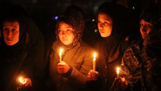 Hazara women hold candles during a memorial for beheaded Hazara victims in Kabul on Tuesday. 