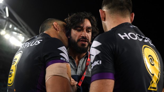Injured Cowboy Johnathan Thurston congratulates Will Chambers (left) and Cameron Smith  after the Storm's grand final triumph.