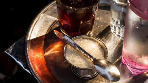A bowl of sugar, as it is traditionally served with tea in Egypt, on a street in Cairo.