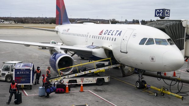 Two people and their dog have leapt from a Delta plane at New York's LaGuardia Airport.