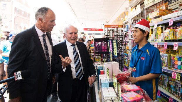 Liberal incumbent John Alexander campaigns with former prime minister John Howard at an Eastwood chemist.
