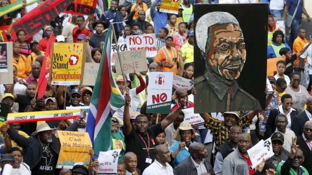 Demonstrators carry placards during a march against xenophobia in downtown Johannesburg.