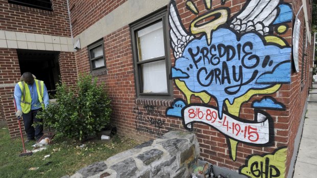 Harvey Jefferson removes rubbish near a memorial for Freddie Gray in Baltimore on Wednesday.