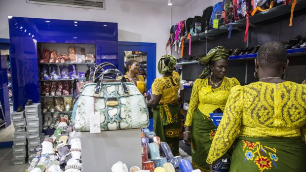 Nigerian women browse in a store at the Delta Mall in Warri, Nigeria, last year.