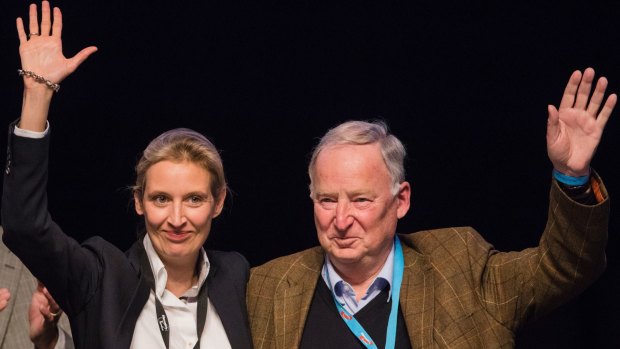 Alice Weidel (left) and Alexander Gauland, members of the AfD (Alternative for Germany), wave to the delegates during the party convention in Cologne, Germany.