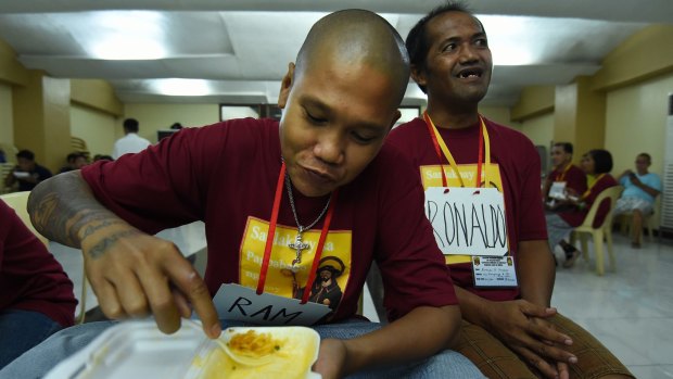 Ramson Donado eats during a break at the San Roque Church rehab program.