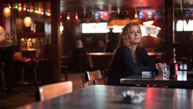 Camille Preaker (Amy Adams) is a journalist who does much of her best work in bars in Sharp Objects.