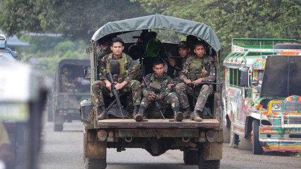 Soldiers ride a military vehicle on the outskirts of Marawi city, southern Philippines, earlier this month.