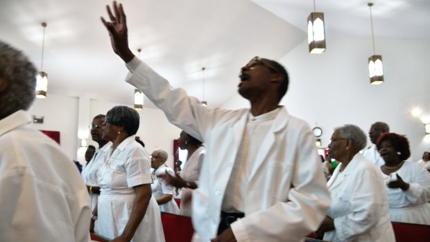 Singing and praying at the Hall United Methodist church in Maryland. 