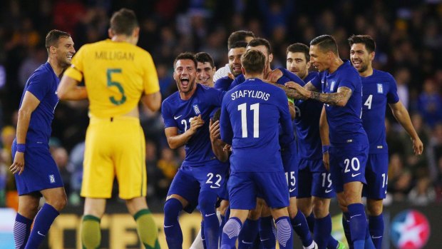 Winning feeling: Ioannis Maniatis of Greece is mobbed by teammates as he celebrates a goal.