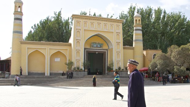 An elderly Uighur man in front of Kashgar's Id Kah mosque, Xinjiang, China.