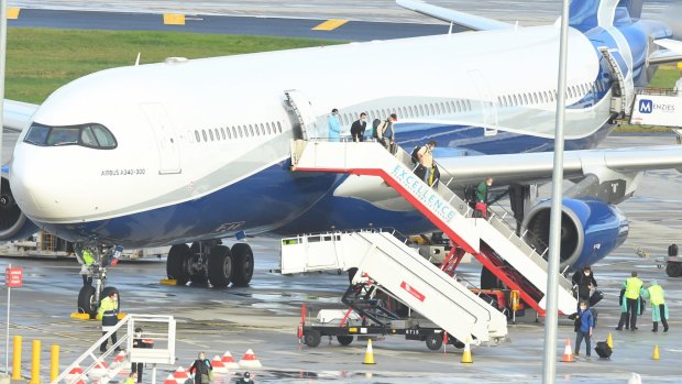 Passengers from the cruise ship Greg Mortimer disembark at Melbourne Airport after a charter flight from Montevideo, Uruguay, on board a Hi Fly Airbus A340.