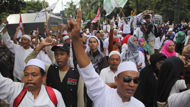 Indonesian Muslims  demonstrate outside the court where Jakarta Governor Basuki Tjahaja Purnama, also known as Ahok, is facing blasphemy charges.