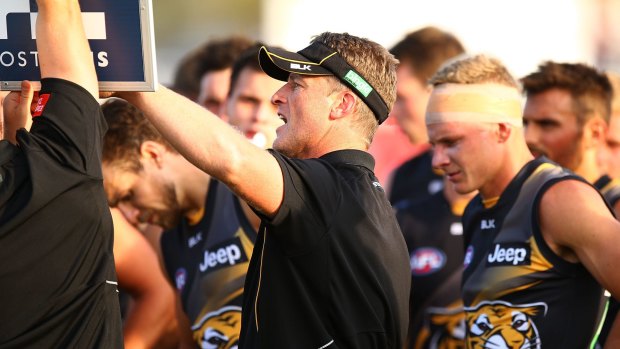 Damien Hardwick talks to his players during a break.