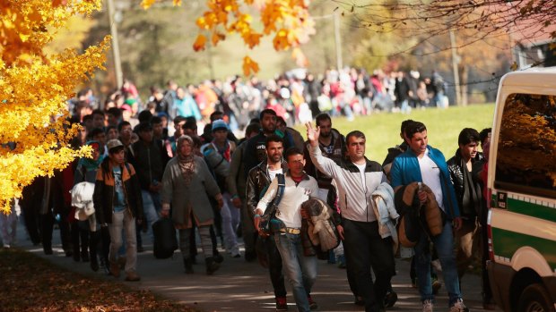 German police lead  refugees from Wegscheid, near the Austrian border to a transport facility on Wednesday.