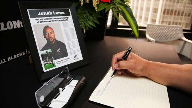Farewell to a legend: A well-wisher signs a condolence book at New Zealand Rugby Union headquarters following Jonah Lomu's death.