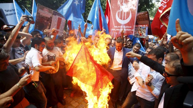Demonstrators set fire to a Chinese flag during a protest against China near the Chinese Consulate in Istanbul in July. 