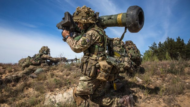 A member of a British Gurkha regiment carries a Javelin anti-tank missile launcher during NATO exercises in Adazi, Latvia, on the front line of defence against Russia.