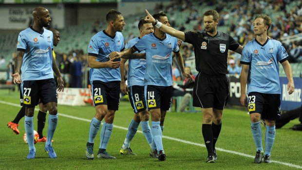 Referee Chris Beath waves away Sydney claims for a penalty.