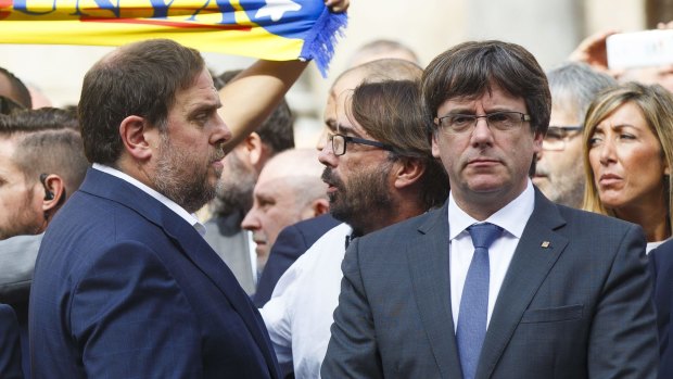 Carles Puigdemont, Catalonia's president, right, and Oriol Junqueras, leader of Esquerra Republicana de Catalunya, join a rally calling for independence prior to the referendum.
