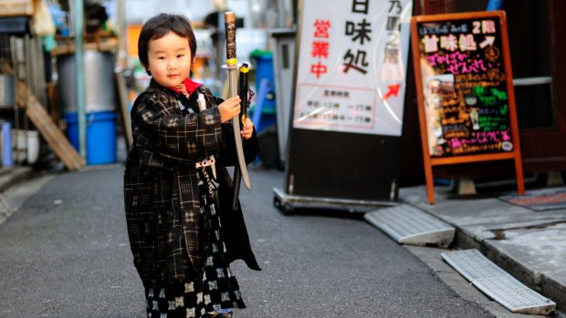 Small boy in traditional costume on the streets of Ningyocho.