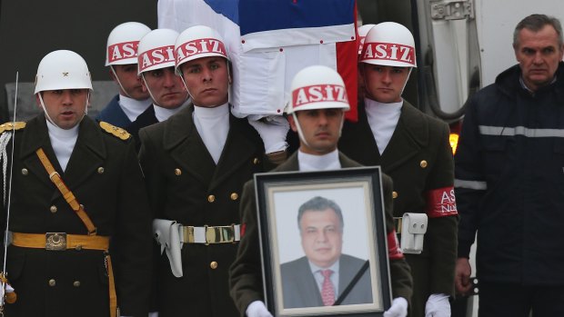 Members of a Turkish forces honour guard carry the Russian flag-draped coffin of Russian Ambassador to Turkey Andrei Karlov during a ceremony at the airport in Ankara, on Tuesday.