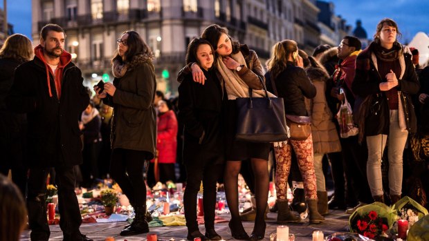 People gather at a memorial site in Brussels on Wednesday.