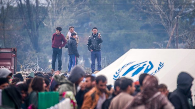 Migrants wait to receive aid in the Greek village of Idomeni  on Thursday.