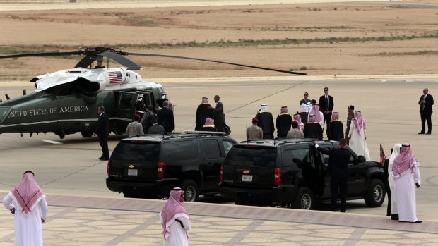 Mr Obama greets Saudi officials on his arrival in Riyadh.