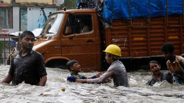 Children play in flood waters in Mumbai, India.