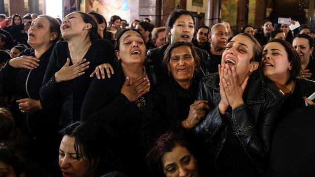 Women cry during the funeral for those killed in a Palm Sunday church attack in Alexandria, Egypt. 